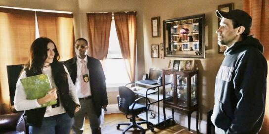 New Bedford District Assistant Chief Probation Officer Kristin Bourgault (left) and New Bedford Probation Officer Carlos Tavares (middle) meet with probationer in his home.