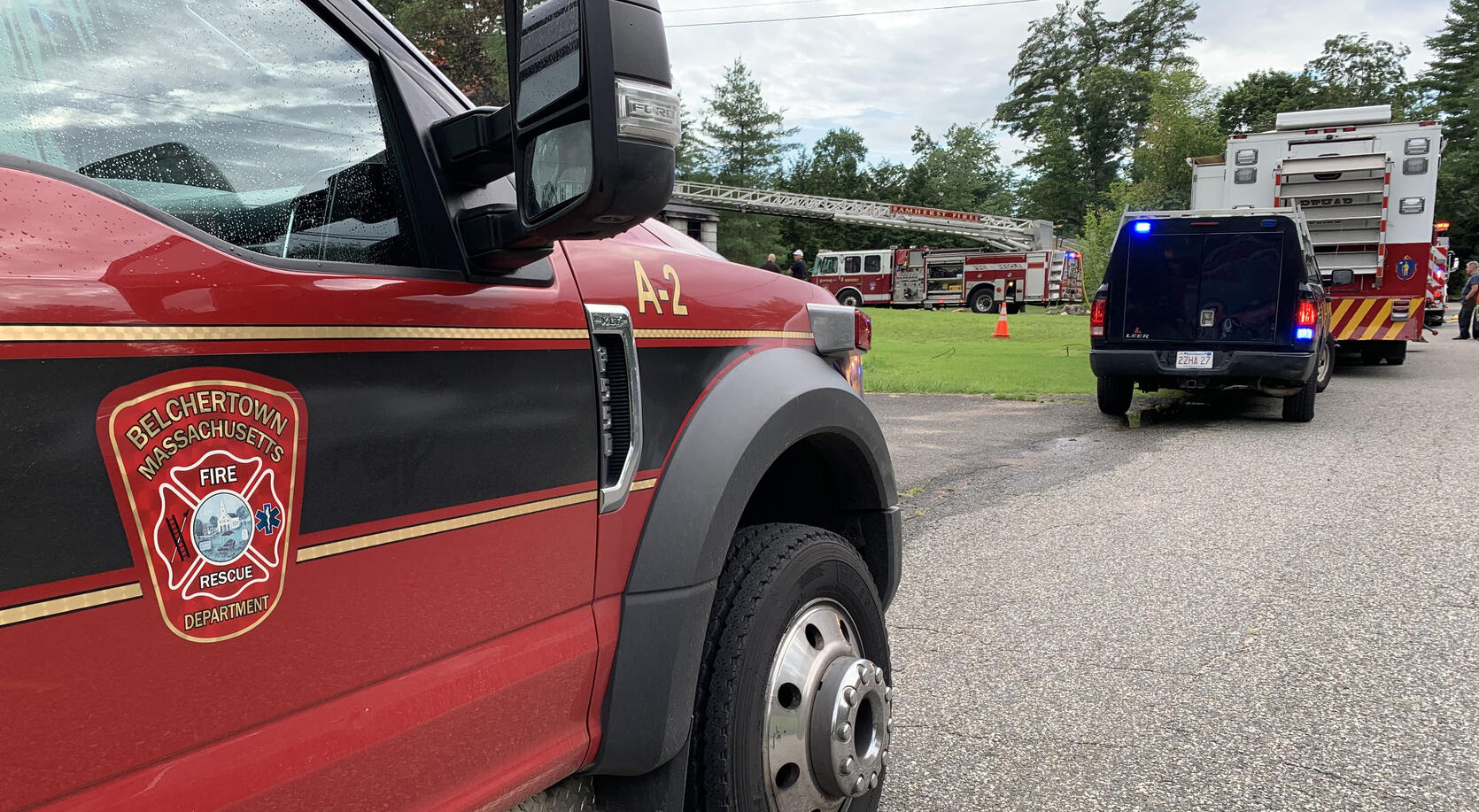 Photo of fire apparatus in front of a house