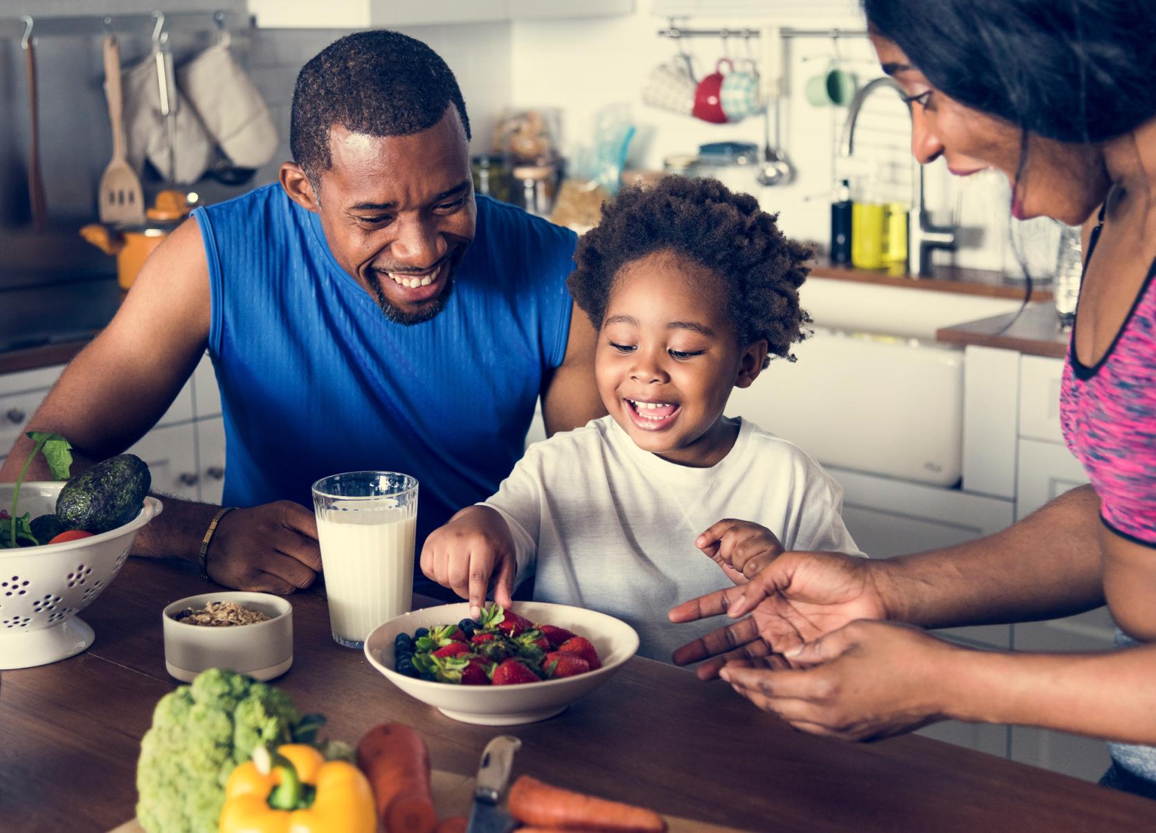 Image of family with young child sharing a healthy meal.