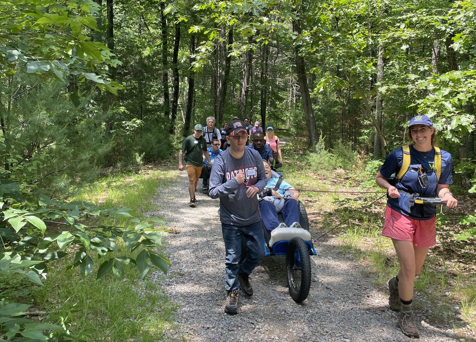 A group of hikers, some using wheelchairs.