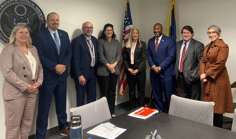 Leaders from the U.S. and Massachusetts Probation Services pose following a meeting. 