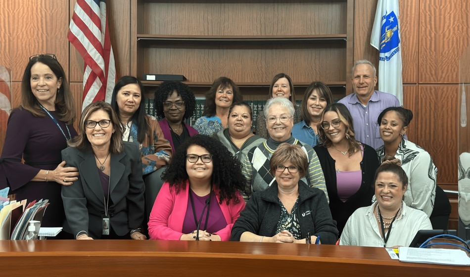 Worcester Juvenile Probation staff celebrate Michaela Wakefield, a recently hired Associate Probation Officer at the court, on Adoption Day