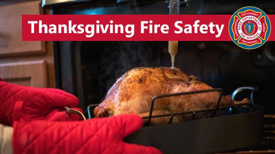 Photo of someone taking a turkey out of the oven with the words "Thanksgiving fire safety"
