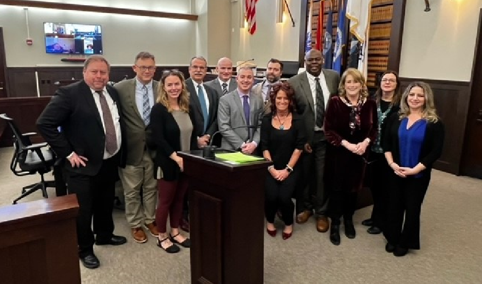 a group pose for a picture in a court room