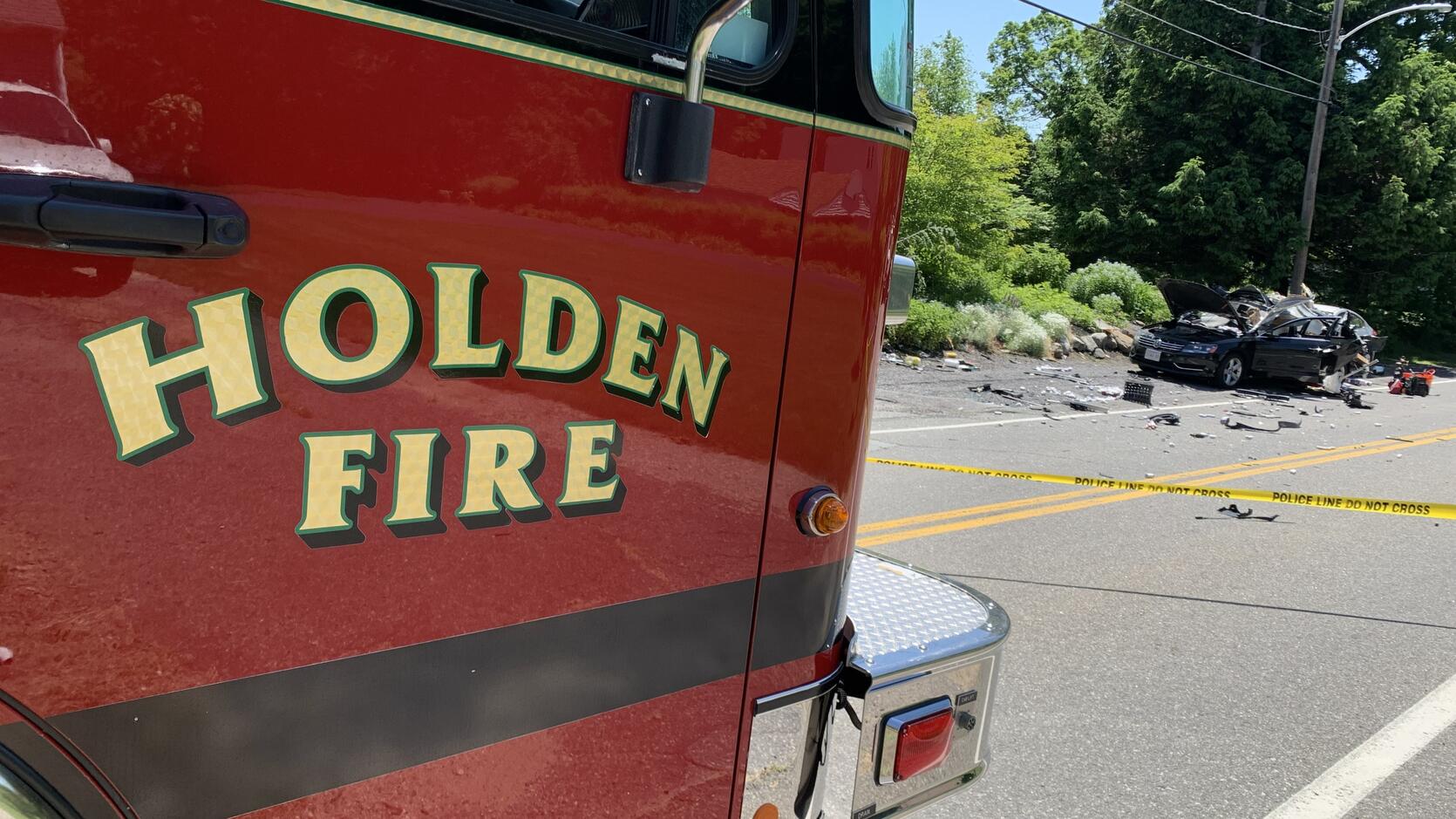 Holden fire engine with a damaged car in the background