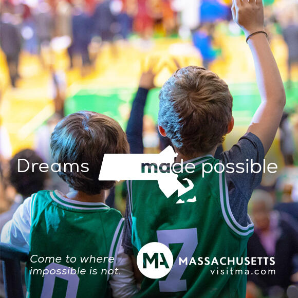 Two little kids with Celtics jerseys with "Dreams Made Possible" text on top.