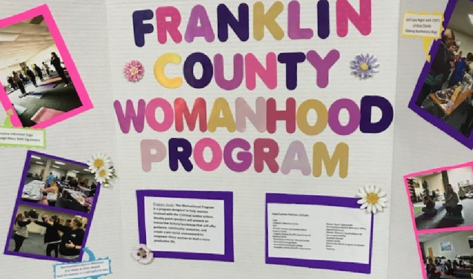 A poster board with large text reading "Franklin County Womanhood program" and pictures.