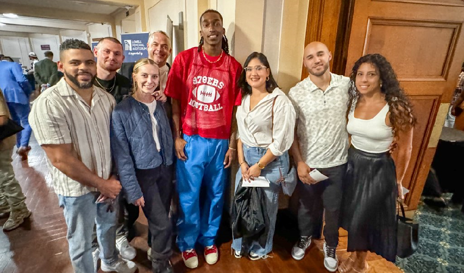 A group of people pose for a picture with NBA player Terence Mann