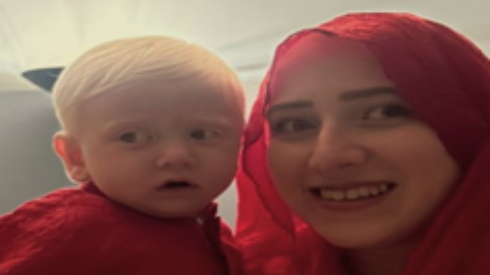 Sundus and one of her children pose for a photo