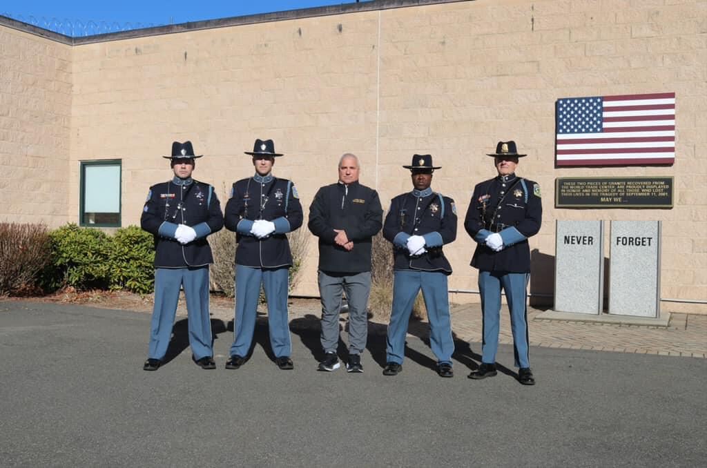 Sheriff Bowler poses with staff members who helped save lives during a traffic accident