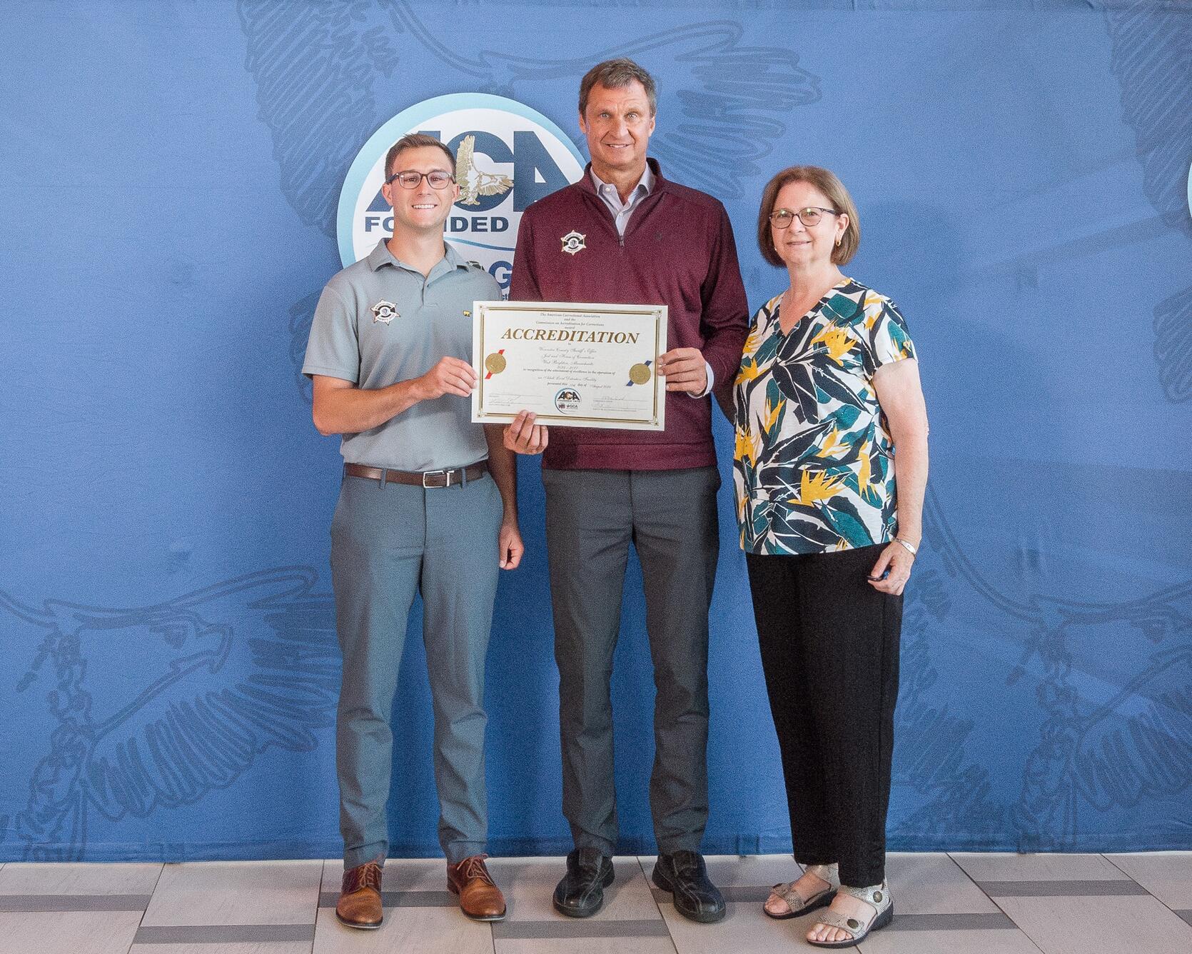 Sheriff Evangelidis poses with staff members with their reaccreditation certificate   