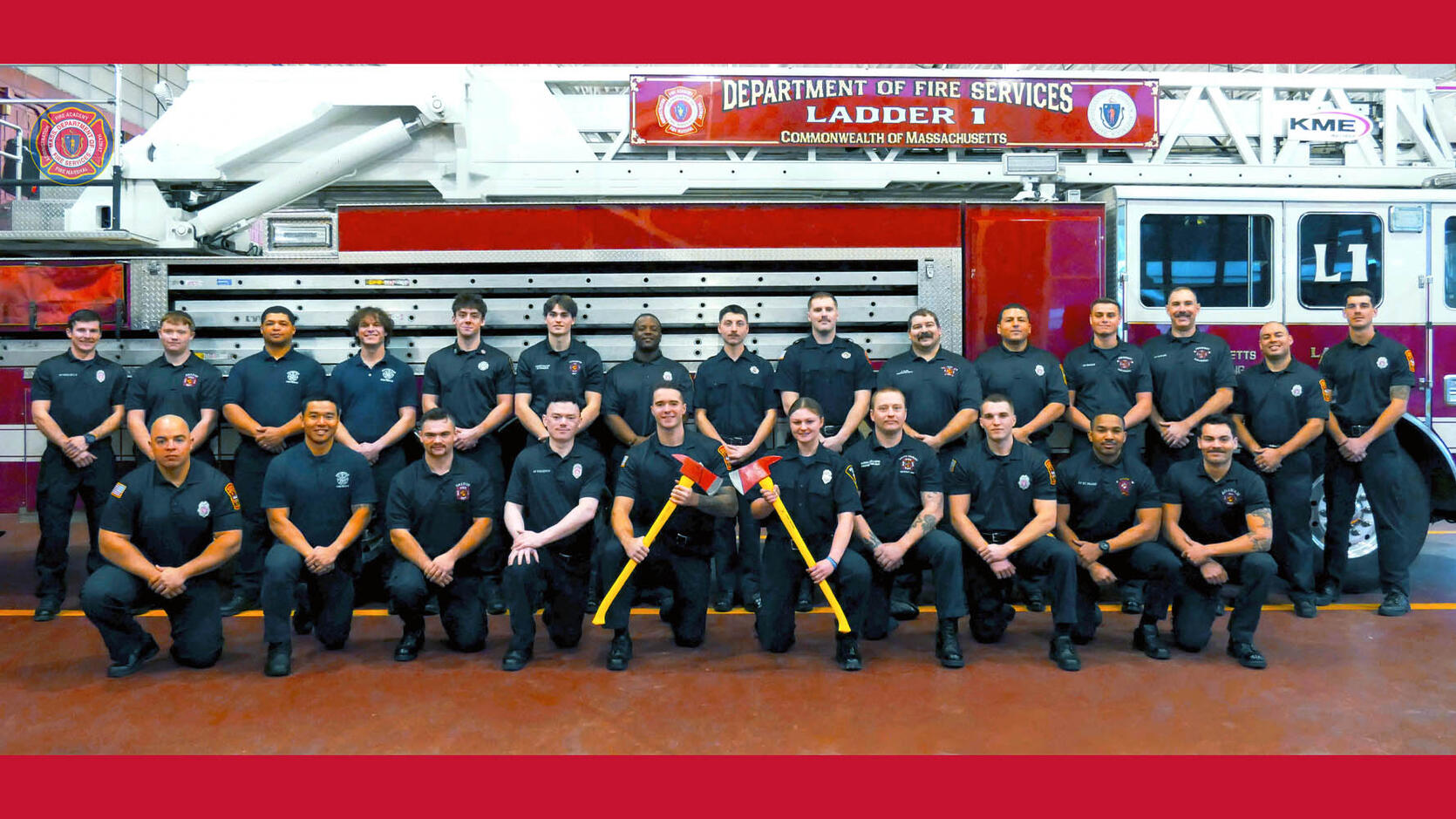 New firefighters in front of a ladder truck