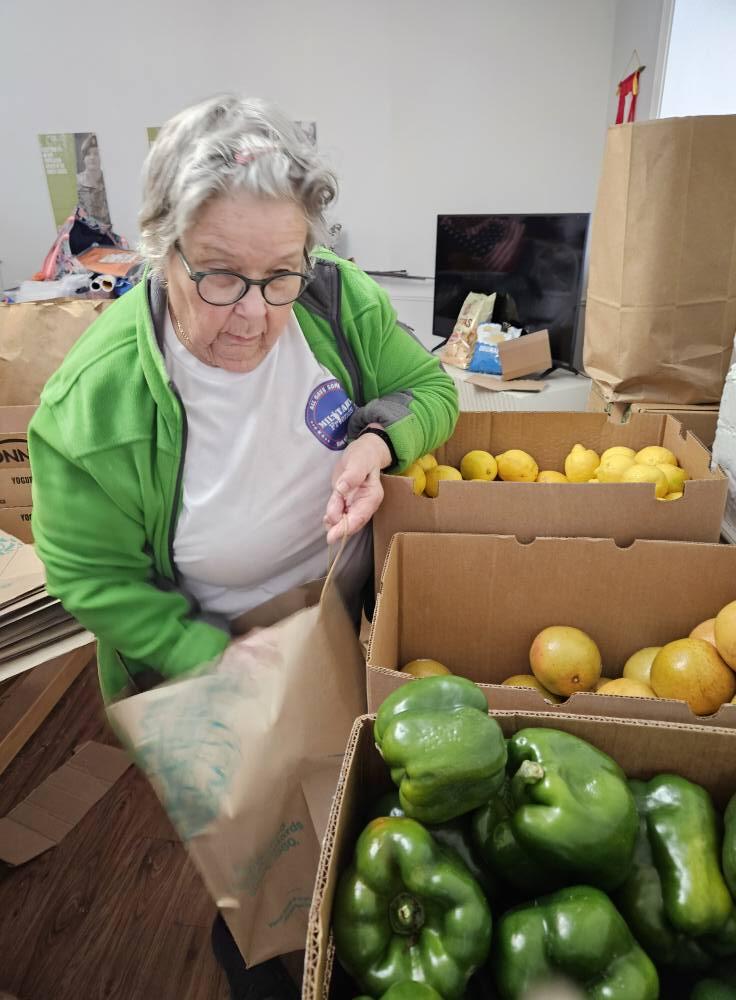 Military Friends member picking out peppers to add to the meal kit