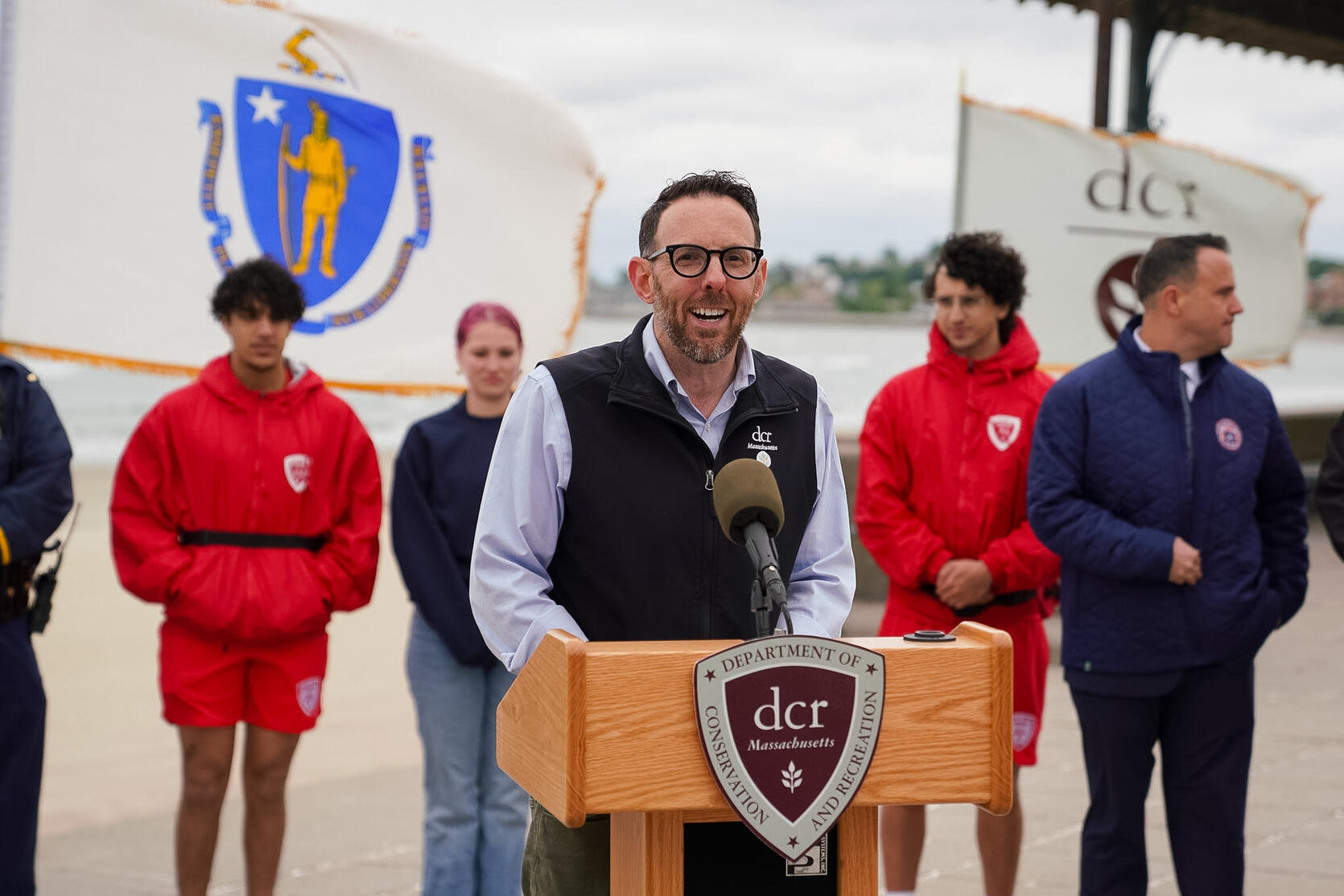 Department of Conservation and Recreation Commissioner Brian Arrigo speaking behind a podium. 