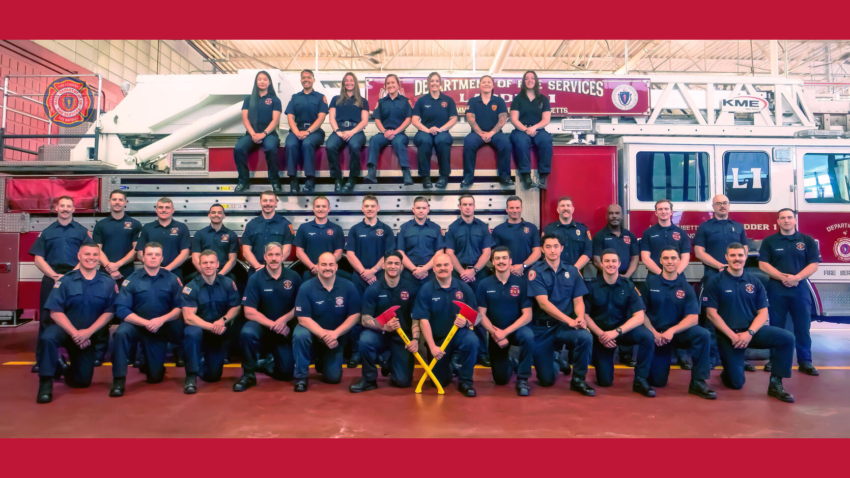 Firefighters on and around a ladder truck