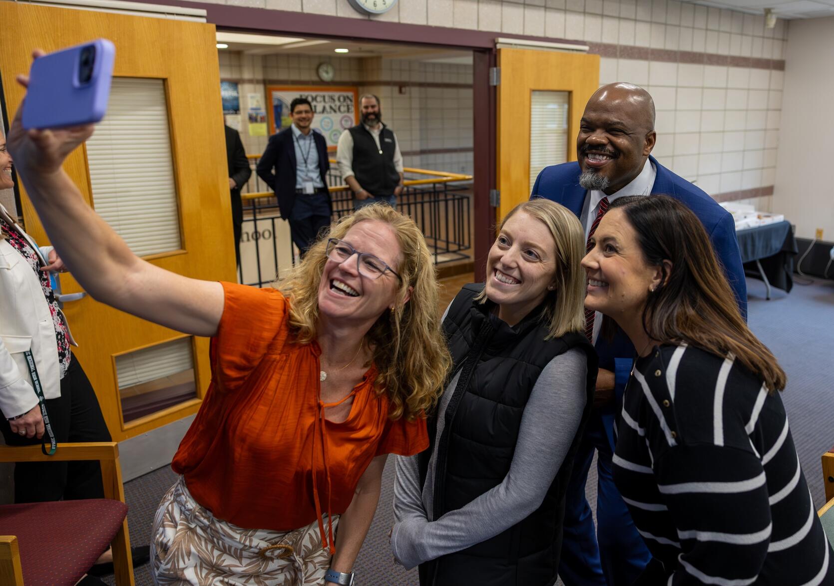 Education Secretary poses for a selfie picture with three teachers from Nipmuc Regional High School