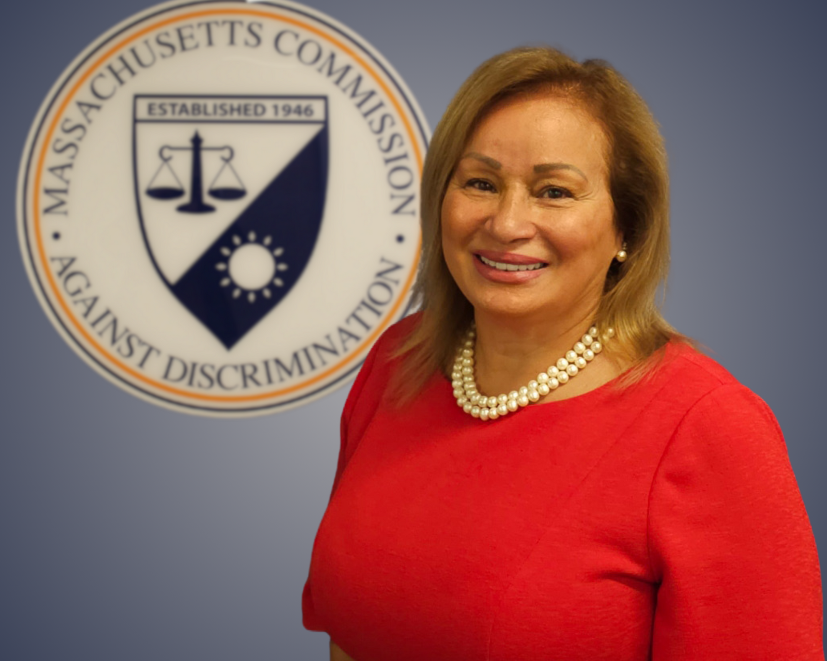 MCAD Commissioner Monserrate Rodríguez Colón Headshot in front of MCAD seal