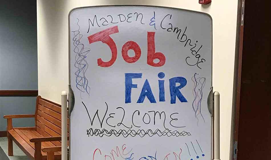 Job fair sign written on a whiteboard.