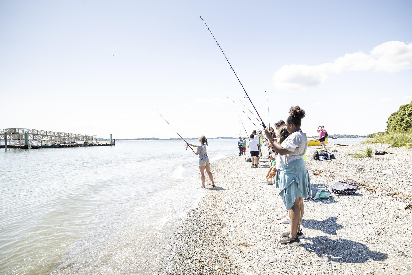 Young anglers fishing from the shore.