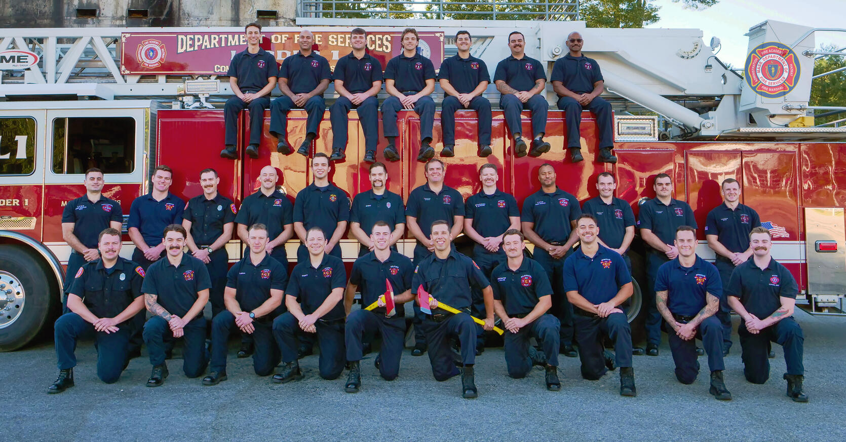 Firefighters on and around a ladder truck