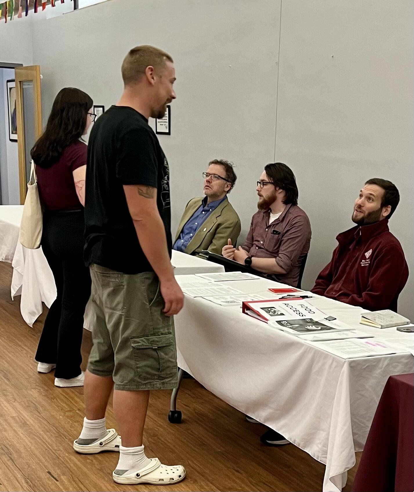 Attendees speak with staff at the 2024 Boston CJSC Open House.