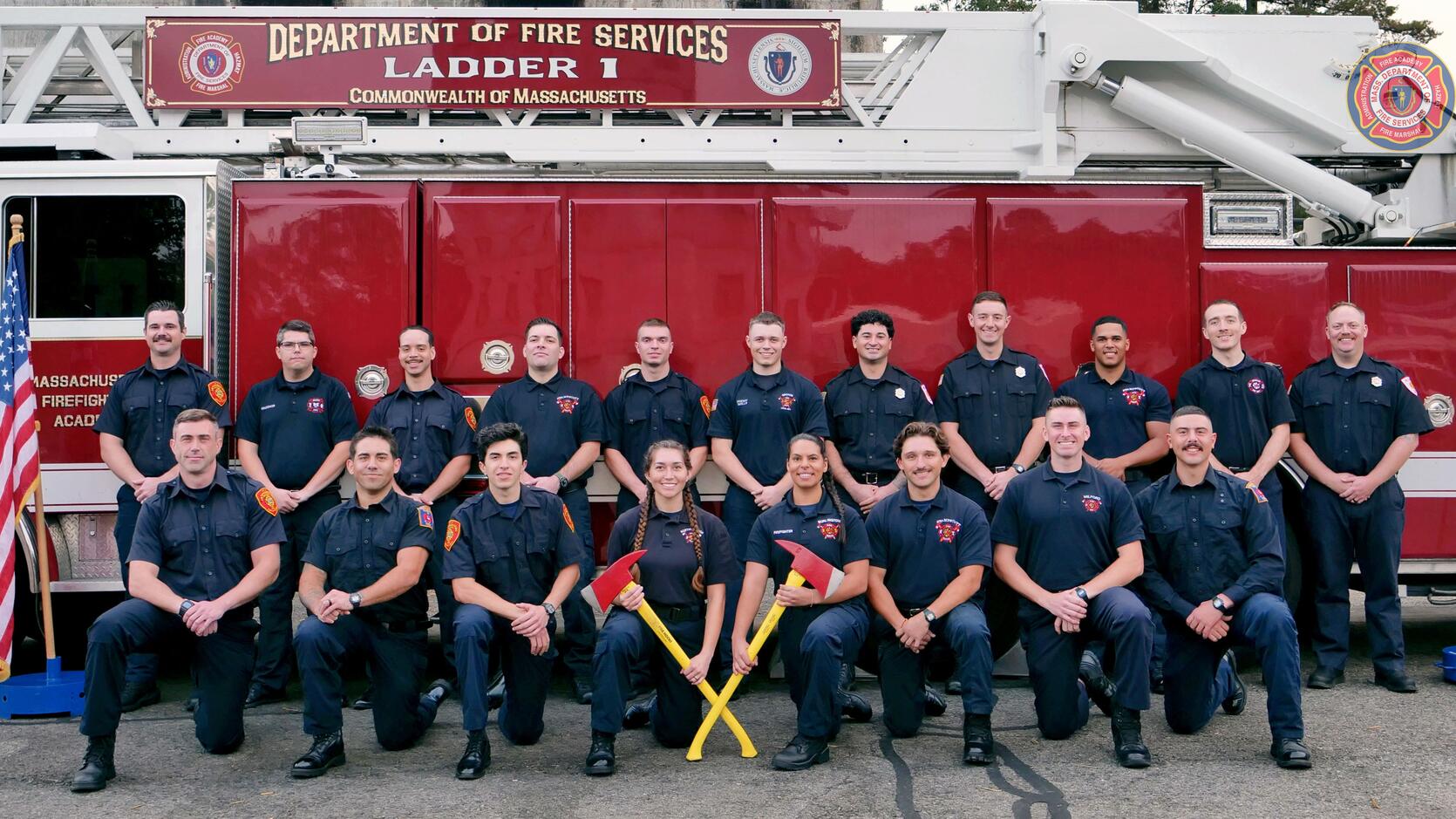 Firefighters on and around a ladder truck