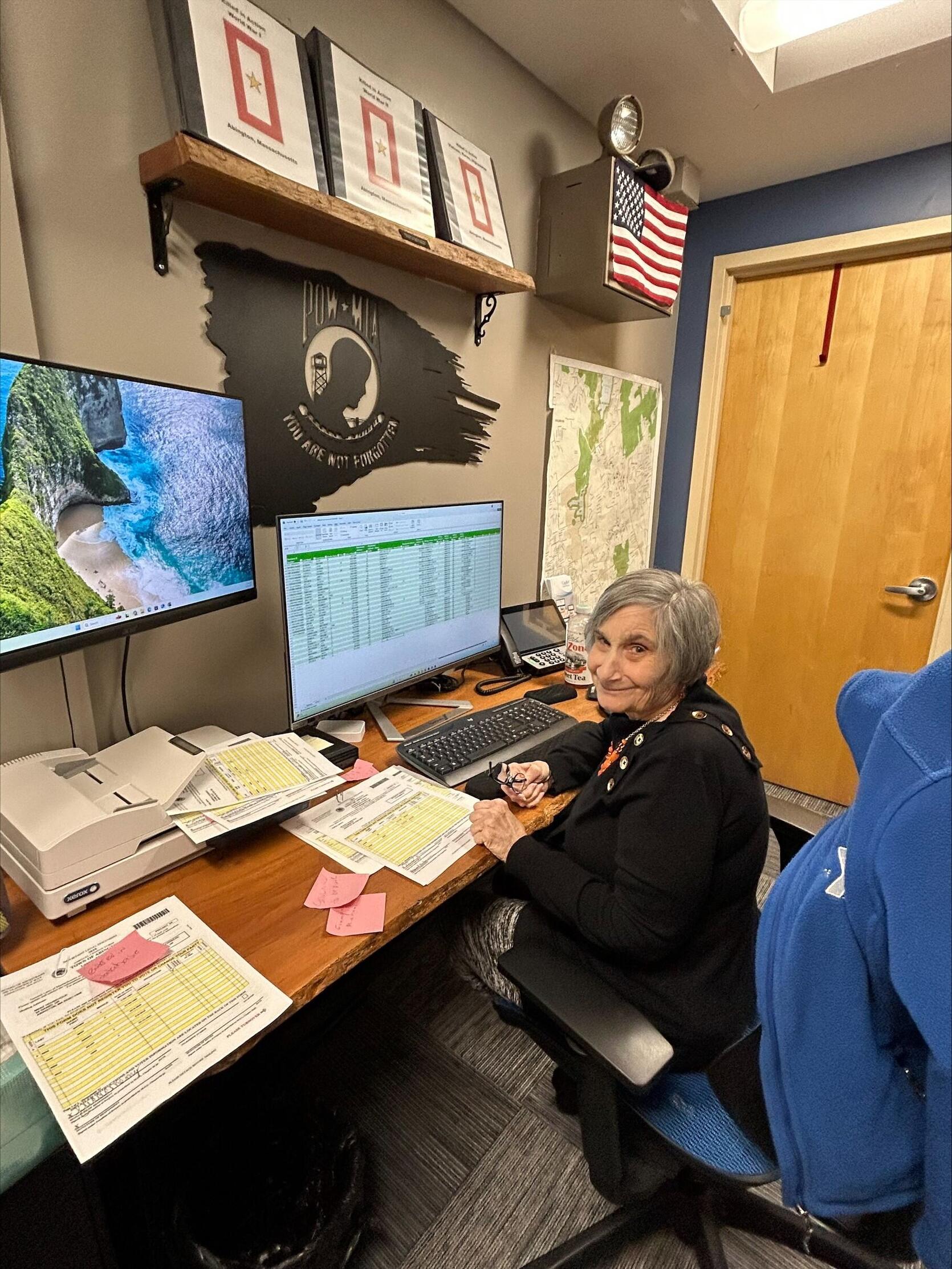 Margaret Carini smiling at her desk