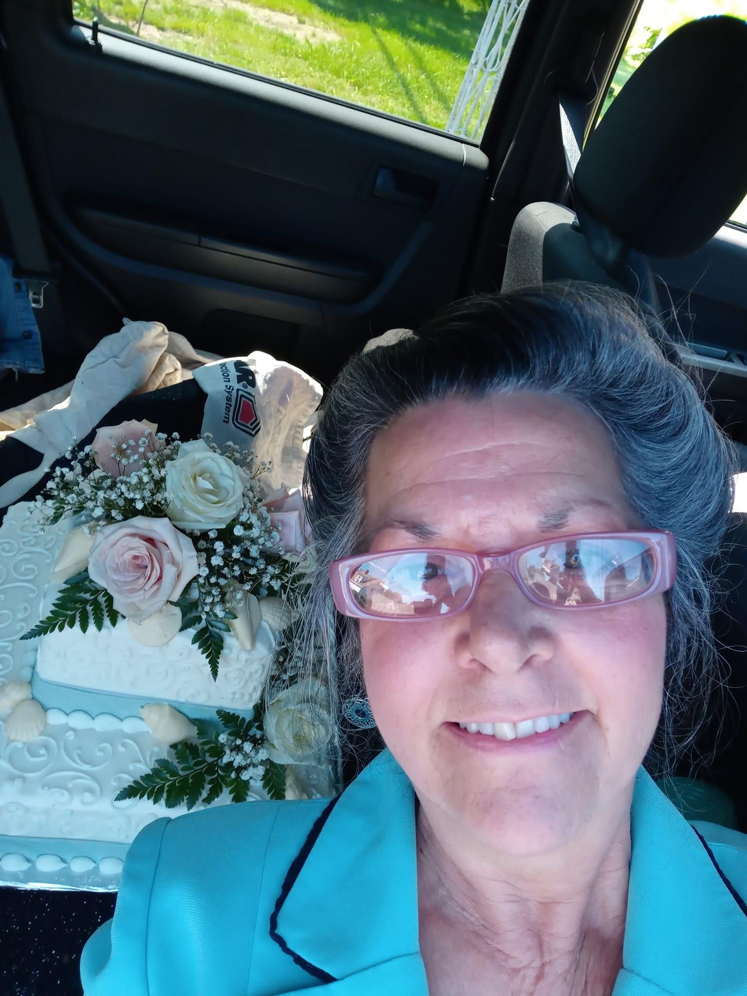 Susan Ferreira-Emery smiling with a cake