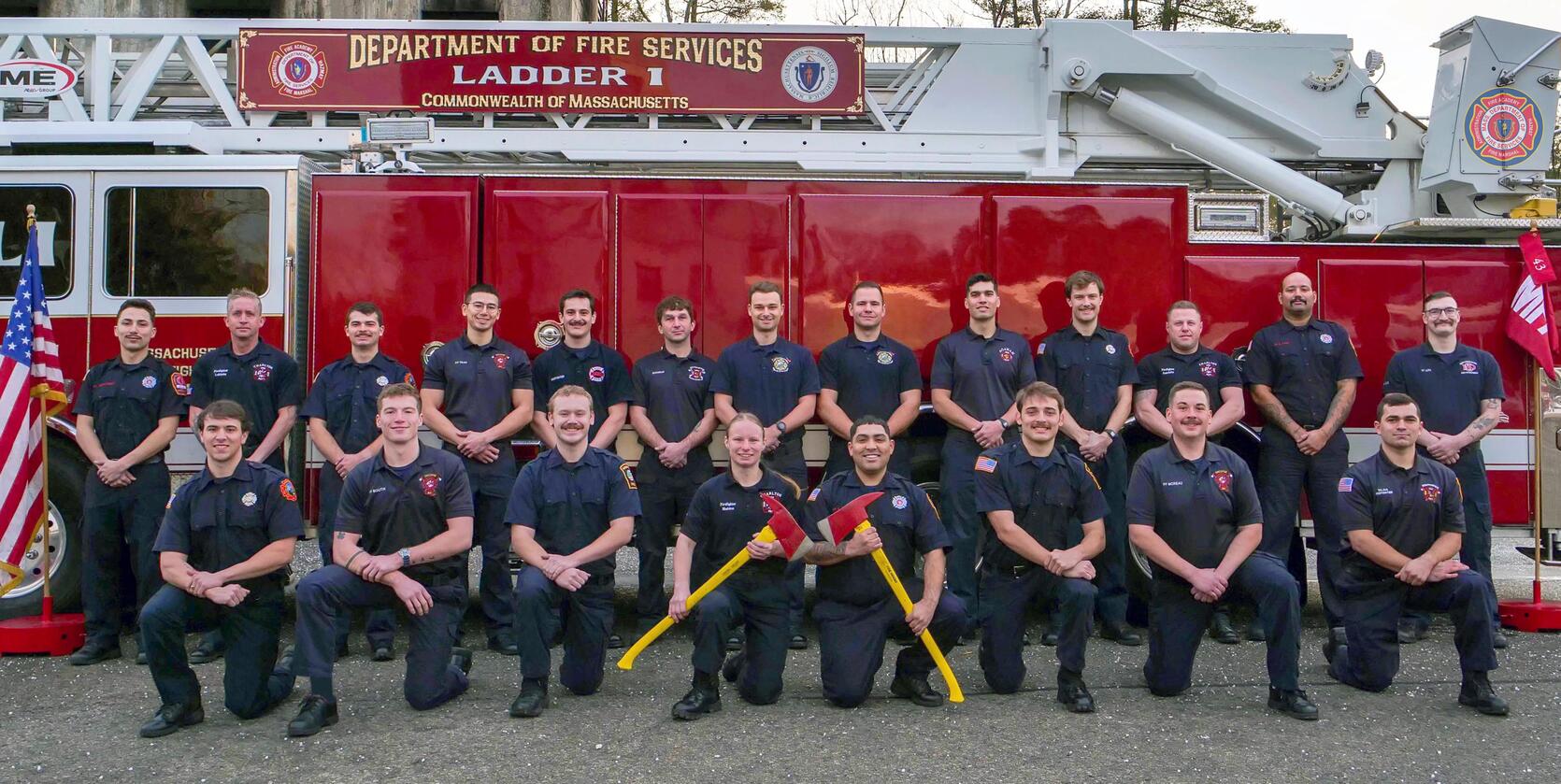 Firefighters on and around a ladder truck