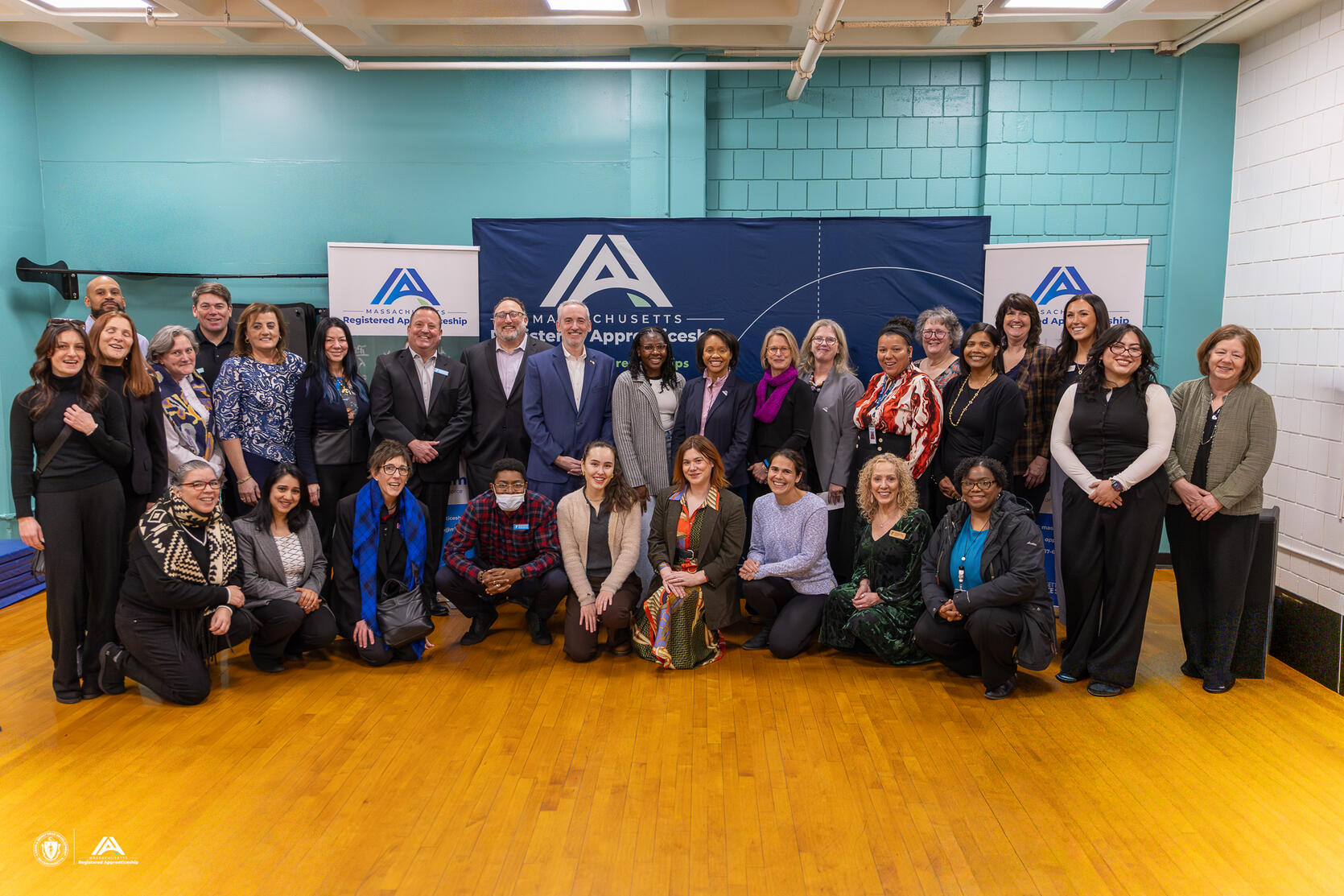 A multi-person group picture featuring grantees and Secretary Lauren Jones