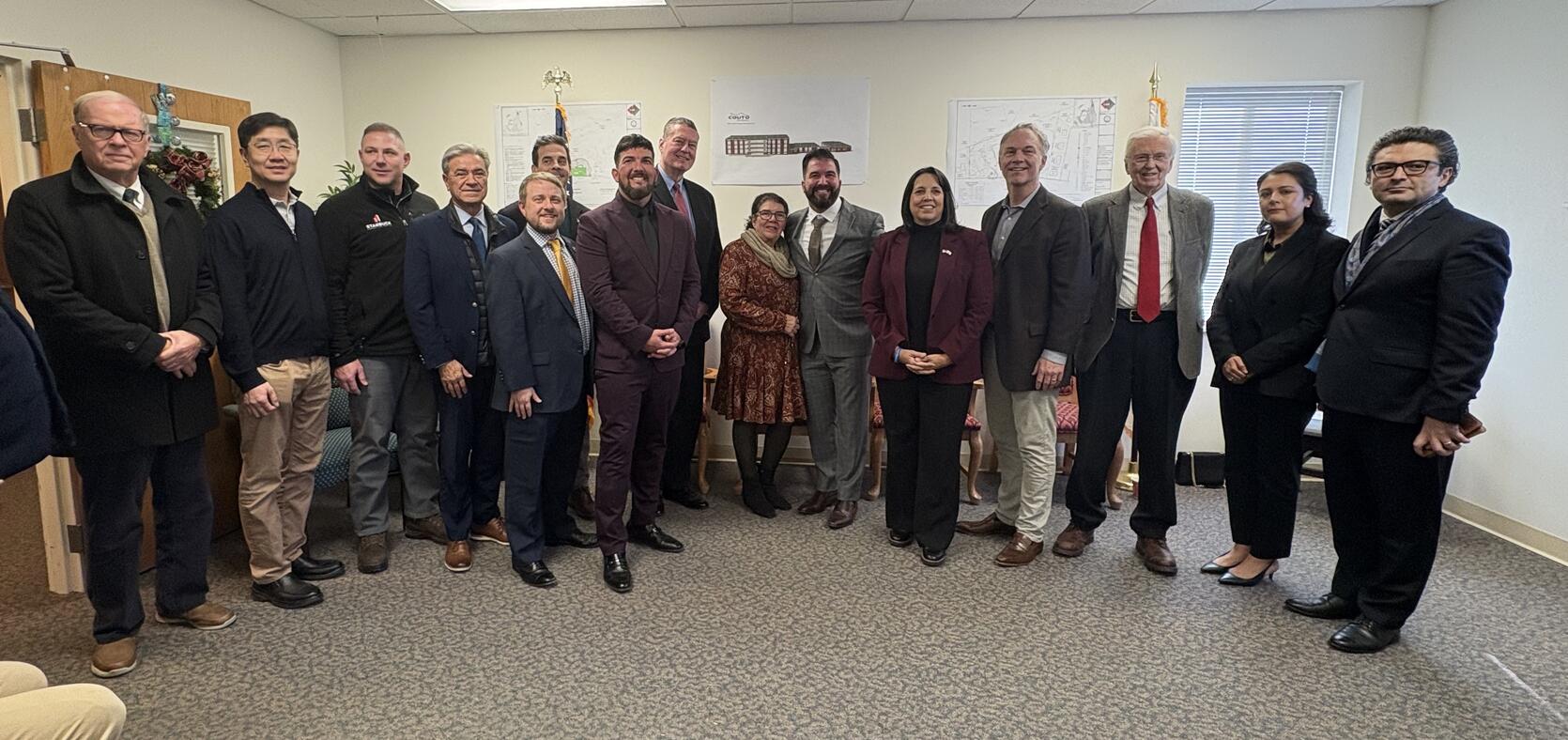 Representatives of the cities receiving HDIP awards gather and pose for a photo