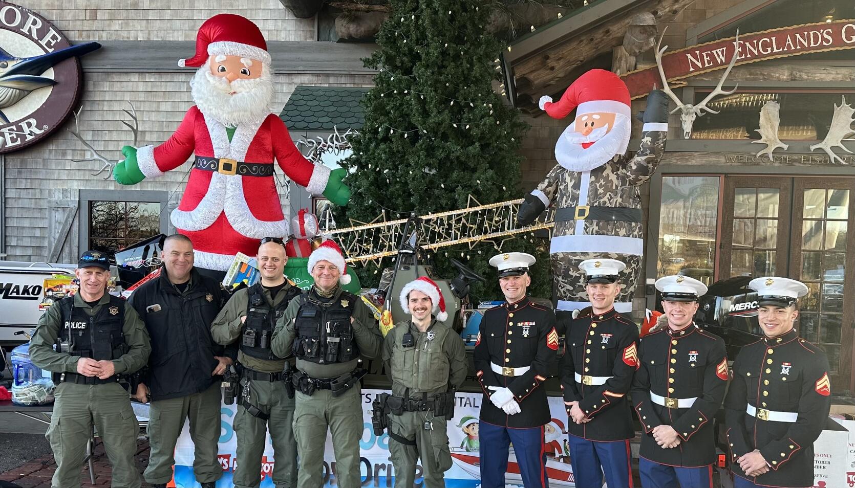 Massachusetts Environmental Police officers and US Marines participate in the Marine Toys for Tots holiday drive. 