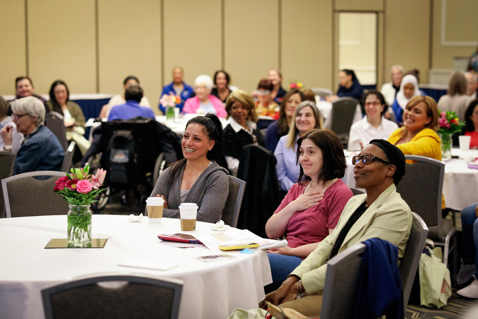 A diverse group of women veterans gathered together smiling at the 2025 Women Veterans Recognition Luncheon