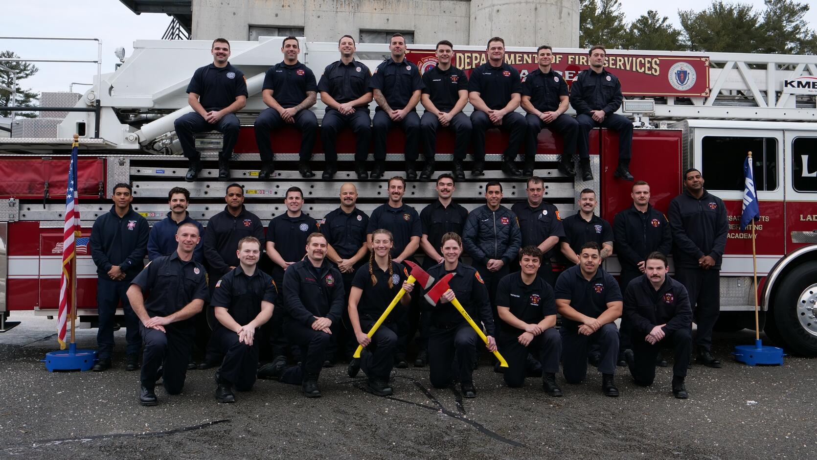 Firefighters on and around a ladder truck