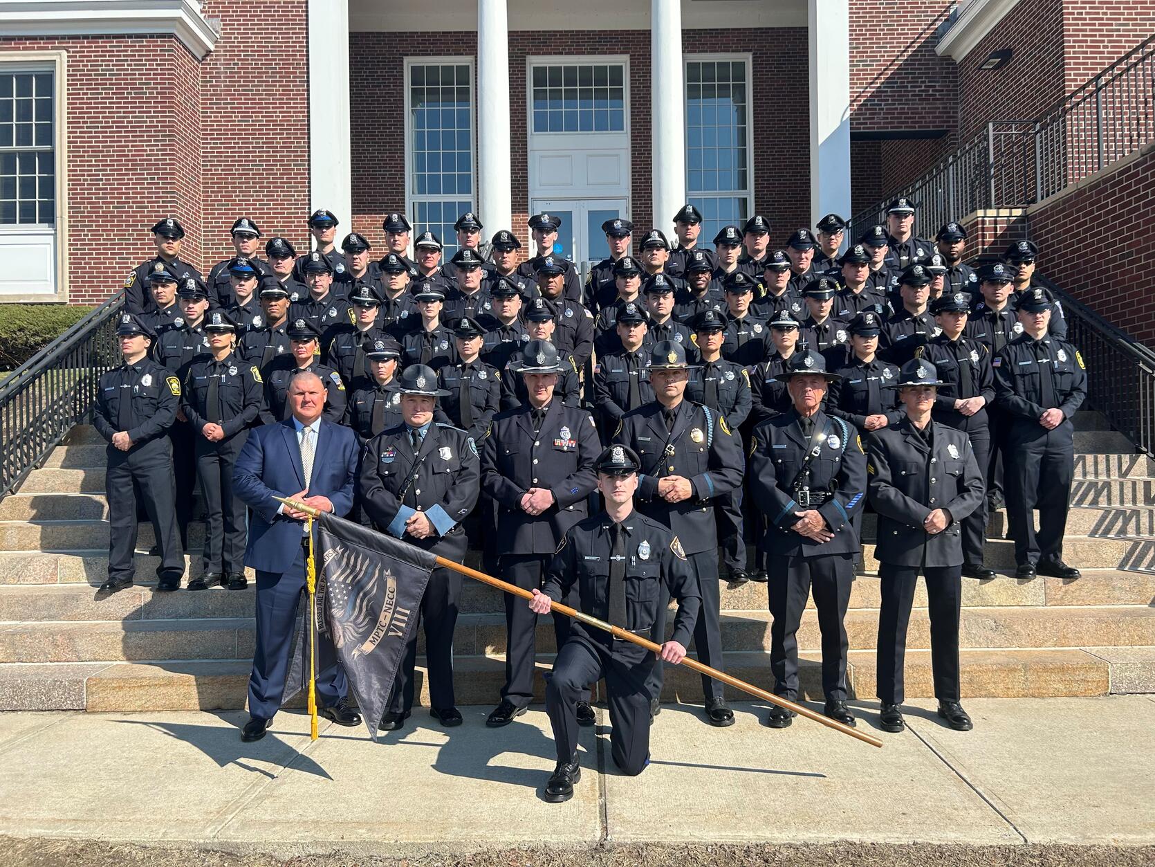 Police Officers pose for a graduation photo