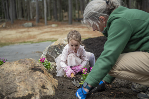 girl and woman planting flowers