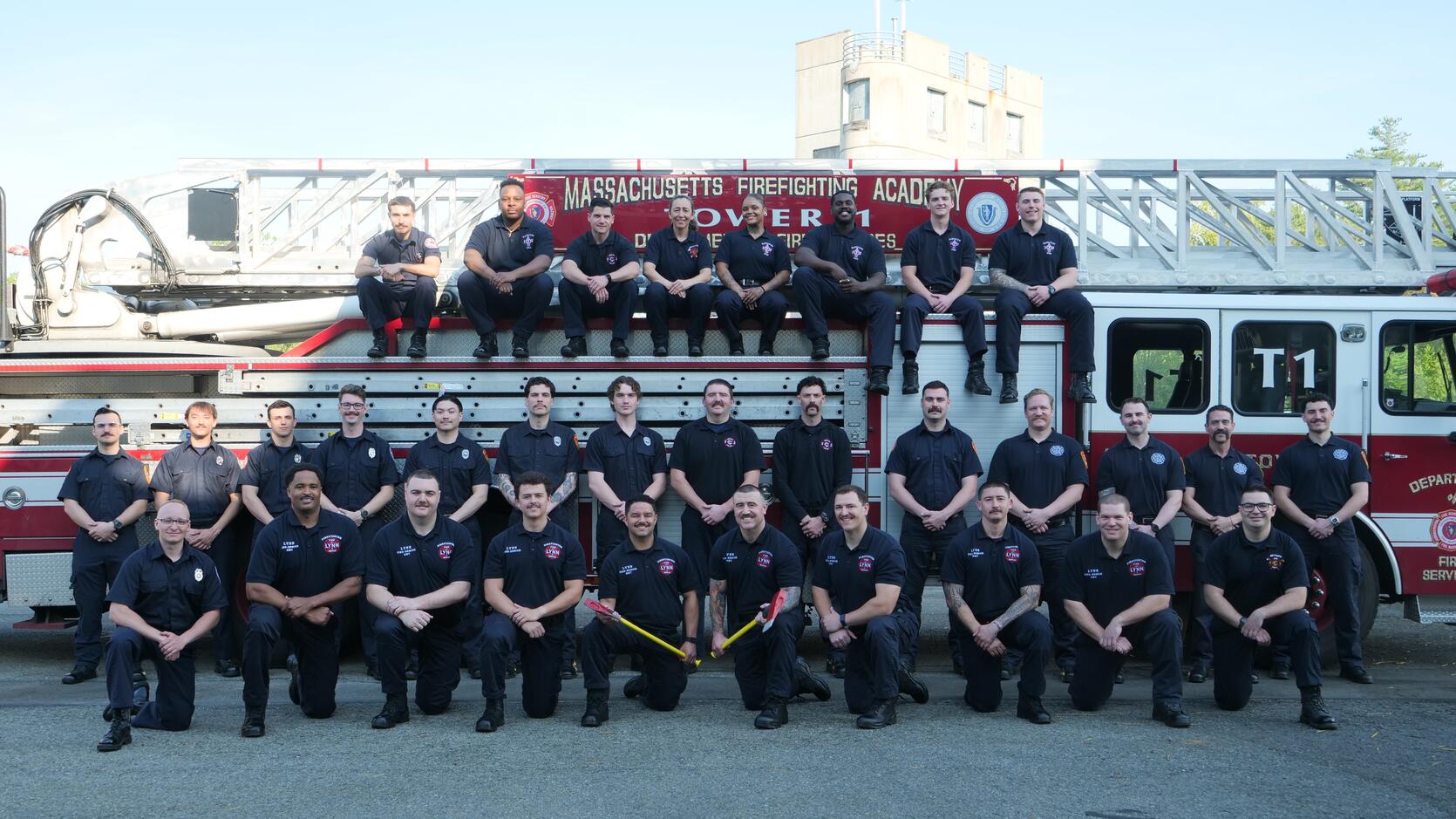 Firefighters on and around a ladder truck