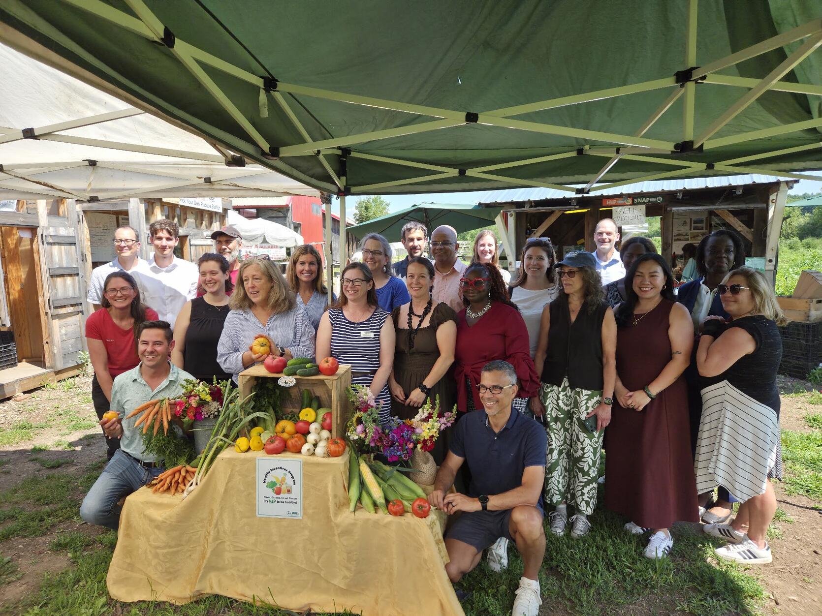 Public officials at an event at Red Fire Farm in Granby, Massachusetts celebrating a $100 Million Milestone for the Healthy Incentives Program (HIP).