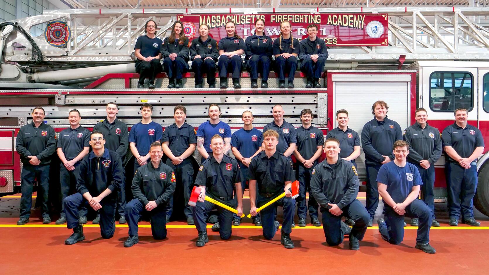 24 new firefighters on and around a ladder truck