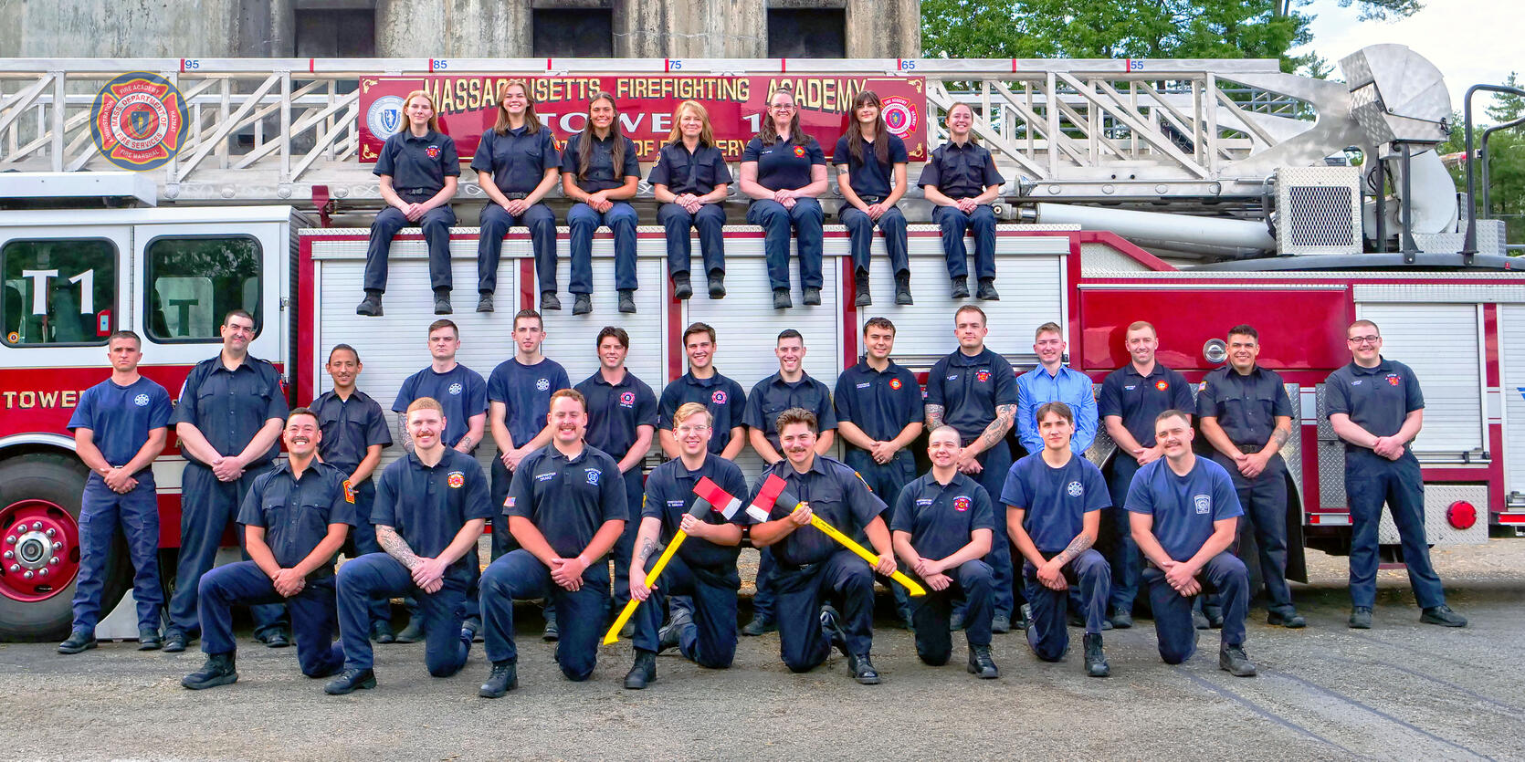 New firefighters on and around a ladder truck