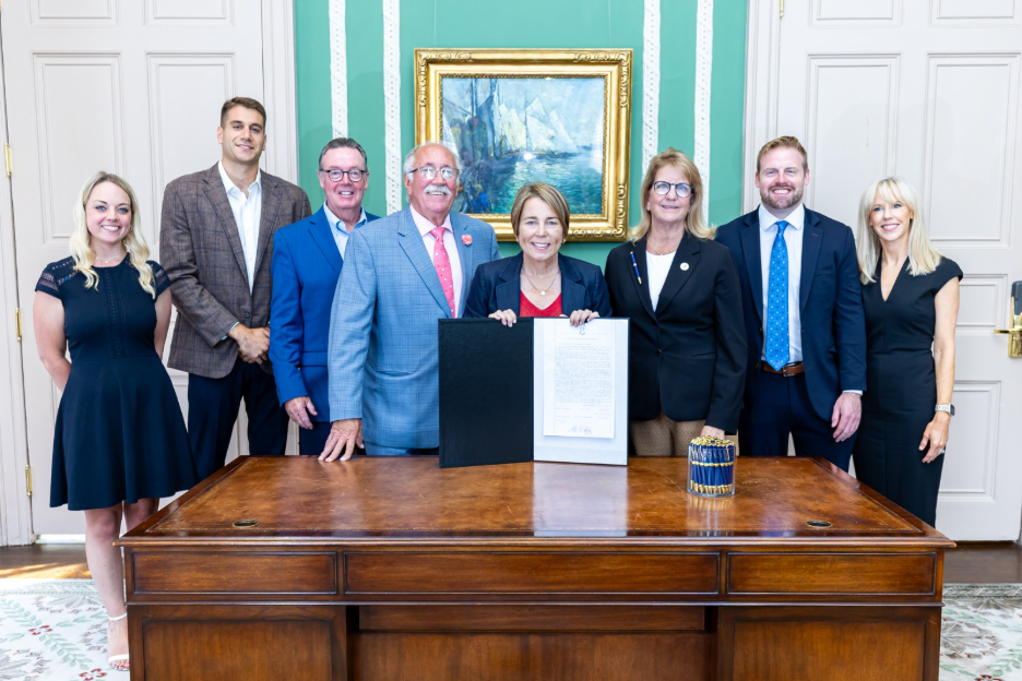 Photo at the signing of the bill with Governor Healey and supporters of the bill. 