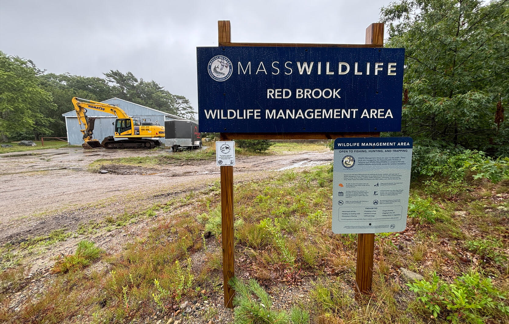 Red Brook WMA sign with construction equiplent in the background