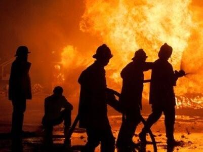 5 firefighters fighting fire at night