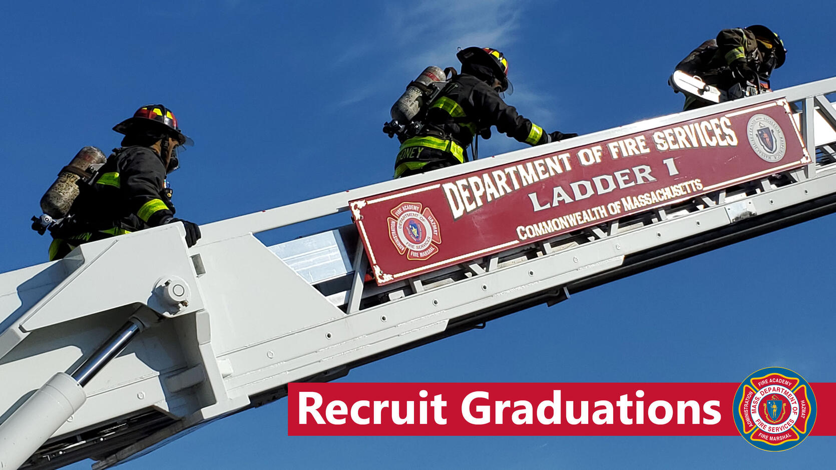Three firefighters on an aerial ladder