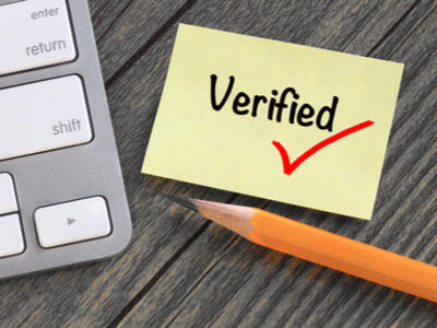 "Verified" written on a sticky note