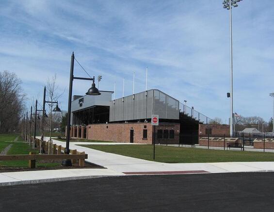 An outdoor field with large bleachers.