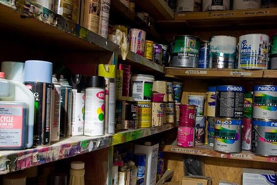 Shelves filled with paint cans.