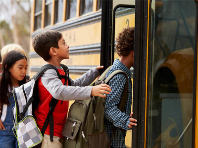 Children getting onto school bus.