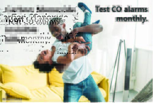 Father and son playing with the text, Carbon Monoxide is an invisible killer. Test CO alarms monthly.