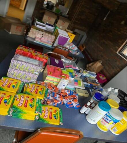 School supplies, including crayons, glue, notepads, hand sanitizer, sanitizing wipes, and more.